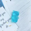 Detailed view of a cute blue frosted semi-transparent bear shaped folding phone grip - Expanding Stand / Light Blue Frosted Bear