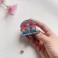 Close-up detail of funny skeleton acrylic retractable badge reel with humorous text - Everything is Fine Style (Skeleton with Coffee)