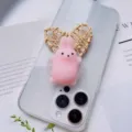 Close-up of pink squishy rabbit phone grip on a clear phone case with heart prop. - Pink Rabbit Style