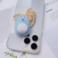 Close-up macro view of cute blue penguin squishy phone grip on transparent phone case - Blue Penguin Style