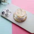Detailed macro view of a vintage pear pattern folding phone grip on a white smartphone - Magnetic Stand / Autumn Moon Pear