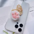 Close-up of a cute 3D cat paw squishy phone grip bracket on a transparent phone case - Cat Paw Style