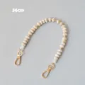Gros plan d'une chaîne en perles acryliques de 36 cm avec fermoirs mousquetons dorés - 36cm / Beige