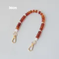 Détail de la sangle en perles de résine ambre de 36 cm avec fermoirs mousquetons dorés - 36cm / Ambre