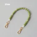 Detailed view of a 37cm green acrylic beaded accessory strap featuring gold lobster clasps - Green