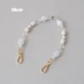 Detailed macro view of 38cm acrylic beaded chain strap with gold lobster clasps - 38cm / White