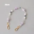 Close-up of a 38cm purple and white acrylic beaded strap with gold clasps - 38cm / Purple