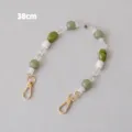 Macro view of 38cm green resin beaded strap featuring gold metal lobster clasps - 38cm / Light Green