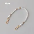 Detailed view of a 37cm elegant white pearl bead chain accessory with gold metal clasps. - 37cm / Apricot