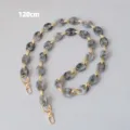 Detail view of a 120cm marble grey resin chunky bag strap with gold lobster clasps - 120cm / Gray