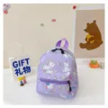 Detailed view of the purple unicorn cartoon backpack for girls in a cute room setting - Unicorn Print / Purple