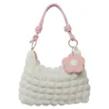 White textured shoulder bag featuring pink knotted strap and decorative flower charm - White & Pink