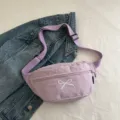 Casual lilac fabric fanny pack featuring white bow embroidery and an adjustable strap - Purple