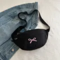 Minimalist black fabric waist bag featuring a pink bow embroidery and adjustable strap - Black