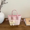 Stylish pink and white plaid bucket bag featuring a cute dog charm and crossbody strap - With Pendant / Pink