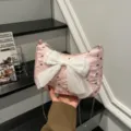 Detailed view of pink bubble gauze shoulder bag featuring a large white decorative bow - Pink