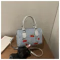 Chic denim handbag featuring red cherry embroidery and metallic silver handles for women - Boston Style / Silver