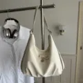 Versatile cream hobo shoulder bag featuring a stylish bow detail and a silver heart pendant - White Without Pendant