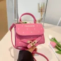 Pink polka dot crossbody handbag with belt buckle and FASHION print detail - Pink