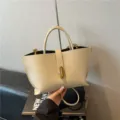 Elegante bolso tote vintage de cuero beige granulado con sofisticado cierre dorado - Blanco Roto