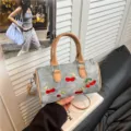 Stylish denim Boston handbag featuring embroidered cherry patterns and brown leather straps - With Pendant / Khaki