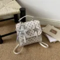Stylish white polka dot mini backpack featuring a shiny star charm for fashionable women - Off-white with Charm
