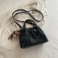 Fashionable black patterned bucket bag with top handle and adjustable crossbody strap - Black
