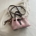 Vintage pink patterned bucket bag with brown handles and cute bear charm pendant - Pink
