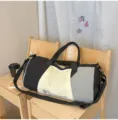 Stylish color-blocked travel duffel bag with large capacity, ideal for gym and weekend trips. - Black
