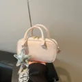 Stylish pink bowling handbag with star charm and crossbody strap for women - With Pendant / Pink