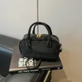 Classic black suede-like bowling pillow bag featuring elegant gold-tone hardware accents - No Pendant / Black