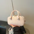 Stylish light pink faux leather bowling handbag with gold-tone hardware detail - No Pendant / Pink