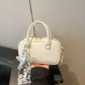 Elegant white faux leather bowling bag with star charm and adjustable crossbody strap - With Pendant / White