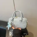 Stylish light blue bowling pillow bag with silver star and balloon dog charm accents - With Pendant / Blue