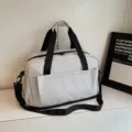 Light gray large capacity travel duffel bag with black straps, perfect for gym and business trips. - Gray