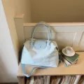 Lightweight blue travel duffel bag with large capacity, cute embroidery and sturdy handles. - Blue