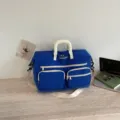 Blue large capacity travel duffel bag with white handles and pockets for sports and gym use. - Dark Blue