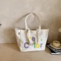 Beige canvas tote bag with colorful embroidered text, casual single shoulder bag variant. - No Pendant / Off White