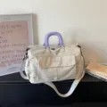 Beige canvas travel duffel bag with purple handle, large capacity gym bag for sports. - Off White
