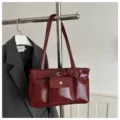 Vintage glossy wine red tote bag with belt detail and front pocket on hanger - Red
