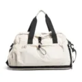 Large capacity travel duffel bag in off-white, expandable gym bag with wet dry separation. - White