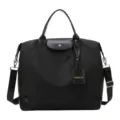 Sac de voyage noir en nylon avec bandouliere et poignees en cuir pour les voyages. - Noir profond
