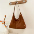 Stylish large brown suede hobo shoulder bag featuring decorative gold rivet studs and top handle - Brown