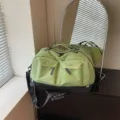 Green travel duffel bag with front pockets and black bottom, spacious gym and sports luggage. - Green