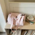 Pink canvas gym duffel bag for women, large capacity travel shoulder bag for short trips. - Pink