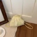 Small yellow and white checkered mini backpack with soft gathered drawstring design. - Yellow