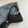 Elegante borsa sottobraccio nera minimalista con logo a trifoglio chic su denim - Nero
