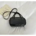 Minimalist black Boston handbag with golden metal accents and adjustable crossbody strap - No Pendant / Black