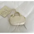 Small cream Boston handbag with top handles and shoulder strap on white fabric - No Pendant / Off White