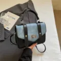 Vintage messenger bag featuring blue denim and black faux leather contrast design - Blue